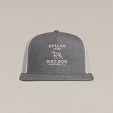 Gray and white Bird Dog Classic Shop Hat by Ballad Originals, featuring “BALLAD of the BIRD DOG BRENHAM, TX” and a bird dog graphic embroidered on the front. Designed for everyday wear, this hat showcases our dedication to quality craftsmanship.