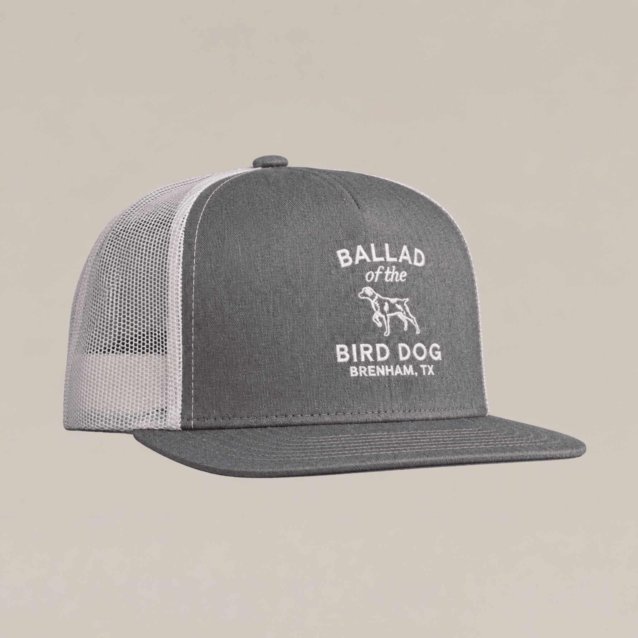 Introducing the Bird Dog Classic Shop Hat by Ballad Originals—a gray and white mesh trucker hat from our Classic Chop Logo Hat collection, featuring our signature shop logo with “Ballad of the Bird Dog, Brenham, TX” and a dog graphic printed on the front panel. A true quality goods accessory.