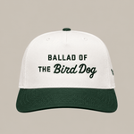 Introducing the Ballad of the Bird Dog Desert Series Hat - Ballad Originals: a stylish 5-panel cap featuring white and dark green panels, a seamless front with “Ballad of the Bird Dog” embroidered on it, and an adjustable snap closure for a comfortable fit.