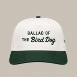Introducing the Ballad of the Bird Dog Desert Series Hat - Ballad Originals: a stylish 5-panel cap featuring white and dark green panels, a seamless front with “Ballad of the Bird Dog” embroidered on it, and an adjustable snap closure for a comfortable fit.