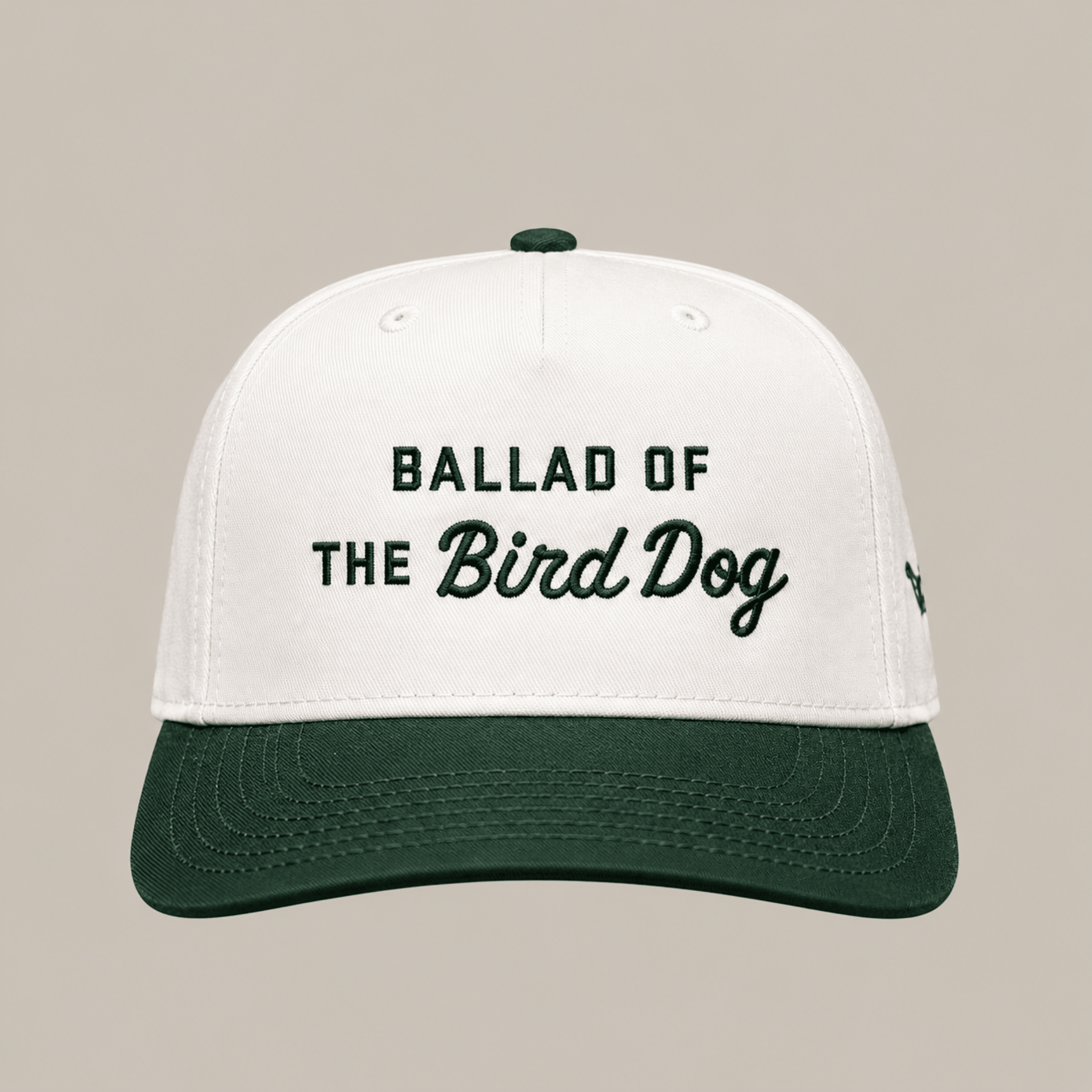 Introducing the Ballad of the Bird Dog Desert Series Hat - Ballad Originals: a stylish 5-panel cap featuring white and dark green panels, a seamless front with “Ballad of the Bird Dog” embroidered on it, and an adjustable snap closure for a comfortable fit.