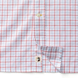 Close-up of a Duck Head Cotton Oxford Sport Shirt in white with red grid pattern, featuring button details and a small person illustration on the inner placket.