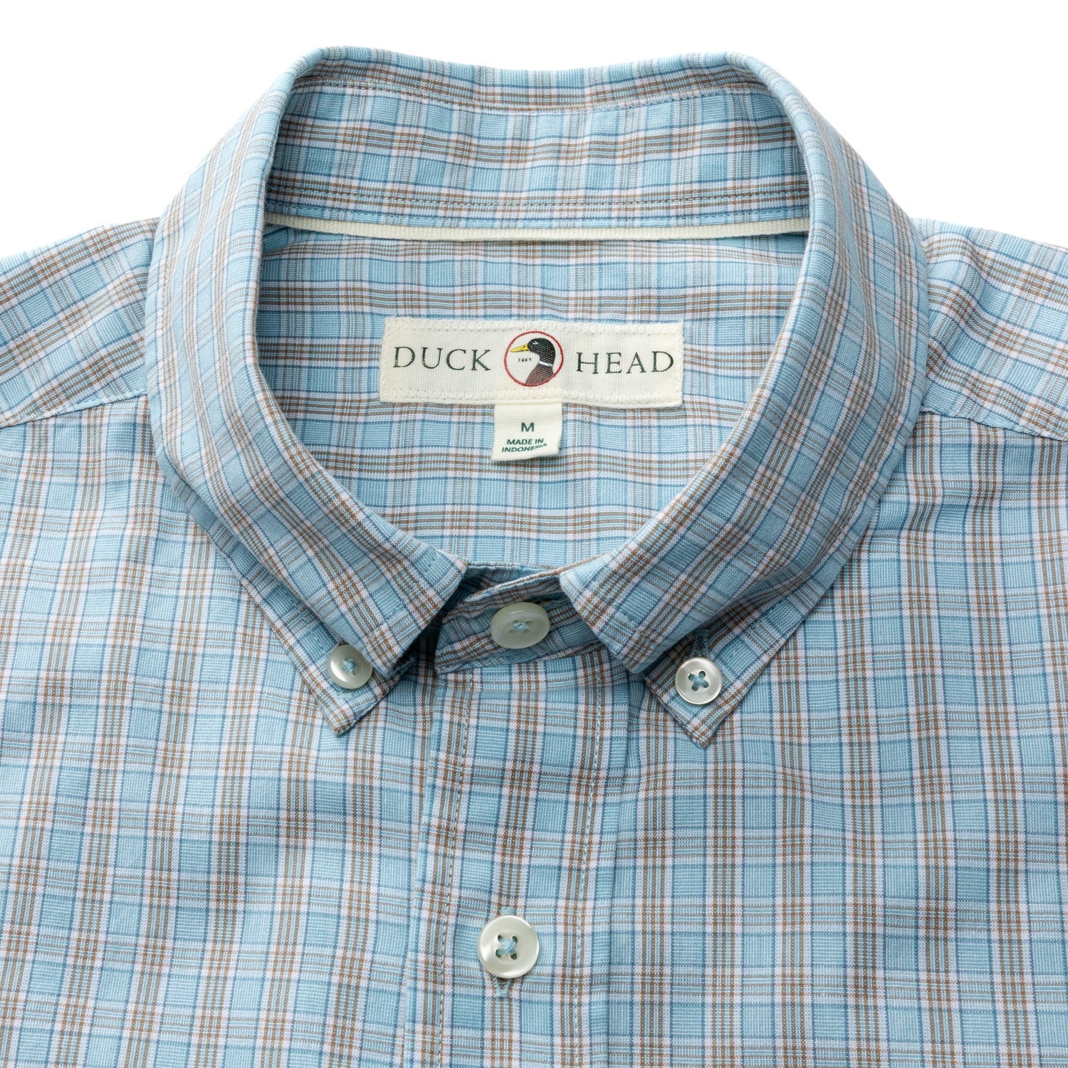 A close-up of the Cotton Cashmere Poplin Sport Shirt by Duck Head in light blue plaid, showing the "Duck Head" label and size M tag inside the collar.