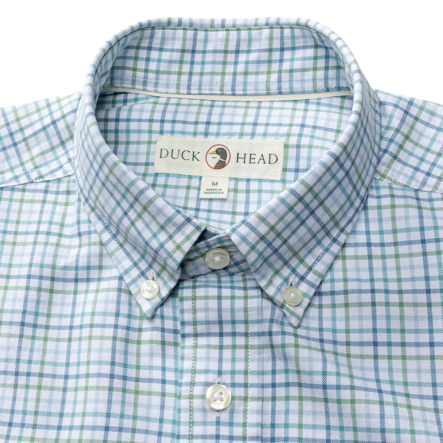 The Duck Head Cotton Oxford Sport Shirt is a blue and green plaid button-down with a collar, OCBD label inside, and mechanical stretch for comfort.