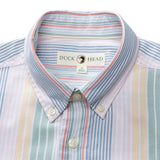 A close-up of the Duck Head Cotton Oxford Sport Shirt, featuring vertical pastel stripes in blue, pink, yellow, and green with mechanical stretch and a "Duck Head" label on the collar.