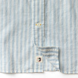 Close-up of the Duck Head Linen Cotton Oxford Sport Shirt, featuring blue and white vertical stripes, a button-down collar, and a small bird logo patch near the hem.