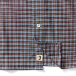 Duck Head Cotton Flannel Sport Shirt in blue and brown cotton flannel, featuring a button placket and a circular logo patch near the hem.