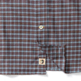 Duck Head Cotton Flannel Sport Shirt in blue and brown cotton flannel, featuring a button placket and a circular logo patch near the hem.