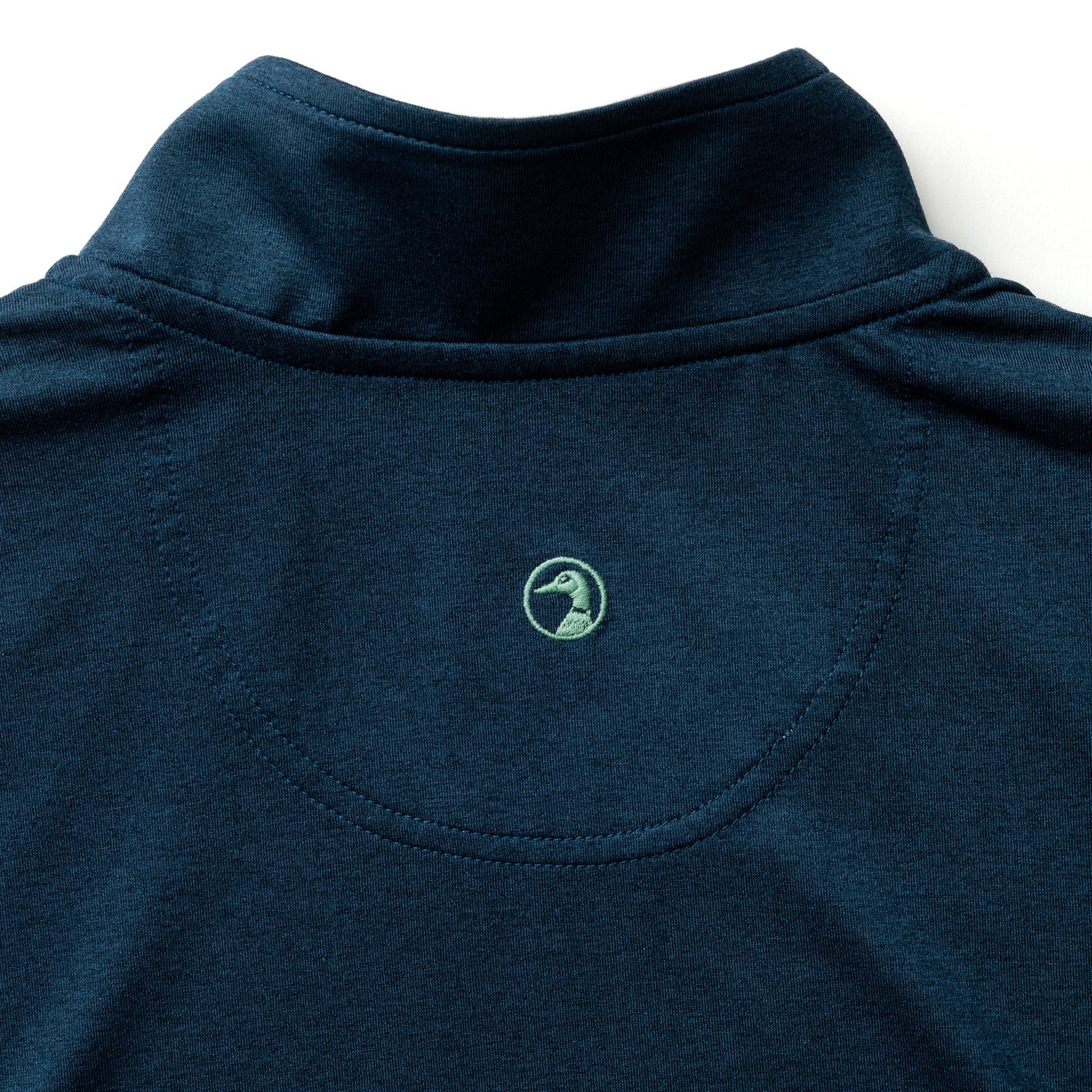 The back of the Duck Head Long Drive Performance 1/4 Zip Pullover in navy shows a small green embroidered duck logo beneath the neckline and is made from moisture-wicking fabric for comfort during any activity.