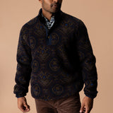 A man wearing a patterned Pineview Fleece 1/4 Snap Pullover over a plaid shirt for lightweight warmth during outdoor activities.