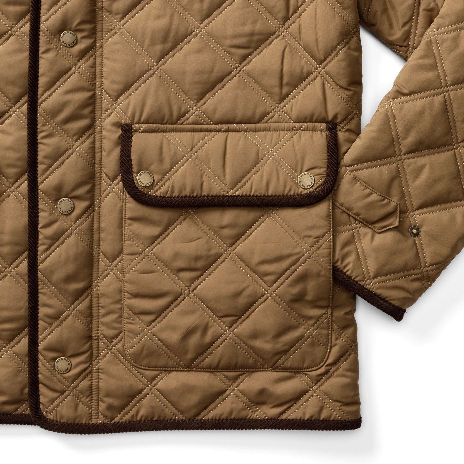 Duck Head Fremont Lodge Performance Quilted Jacket in tan, featuring brown corduroy trim, a flap patch pocket, snap closures, and PrimaLoft insulation.