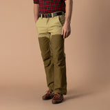 A person wearing a red plaid shirt, a brown belt, leather shoes, and Duck Head Field Canvas Briar Pant in two-tone khaki and olive green.