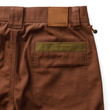 Rear view of brown Duck Head Field Canvas Briar Pant with a tan leather patch above a back pocket featuring an olive green trim.