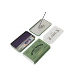 The Collins Do Not Disturb Incense Sticks set features a green tin box labeled “Do Not Disturb” that contains lavender-scented incense sticks made from natural ingredients, a holder, paper clips, and cat illustration cards, all attractively arranged on a white background.