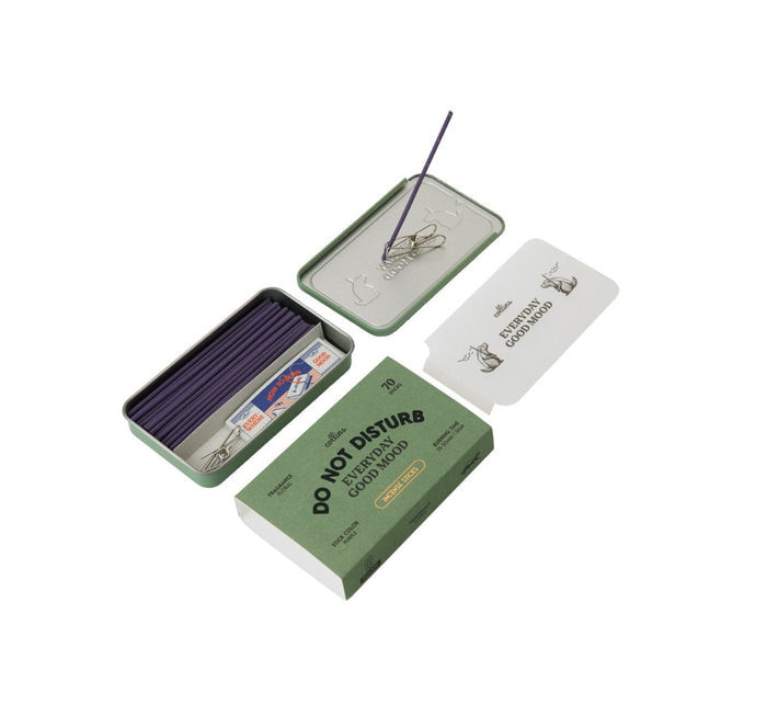 The Collins Do Not Disturb Incense Sticks set features a green tin box labeled “Do Not Disturb” that contains lavender-scented incense sticks made from natural ingredients, a holder, paper clips, and cat illustration cards, all attractively arranged on a white background.