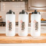 Three Furvor Squeeze Bottles For Dogs, BPA-free with black lids labeled "Fueled by FURJOY," are lined up on a wooden cutting board—perfect for serving Furvor bone broth to your pets.