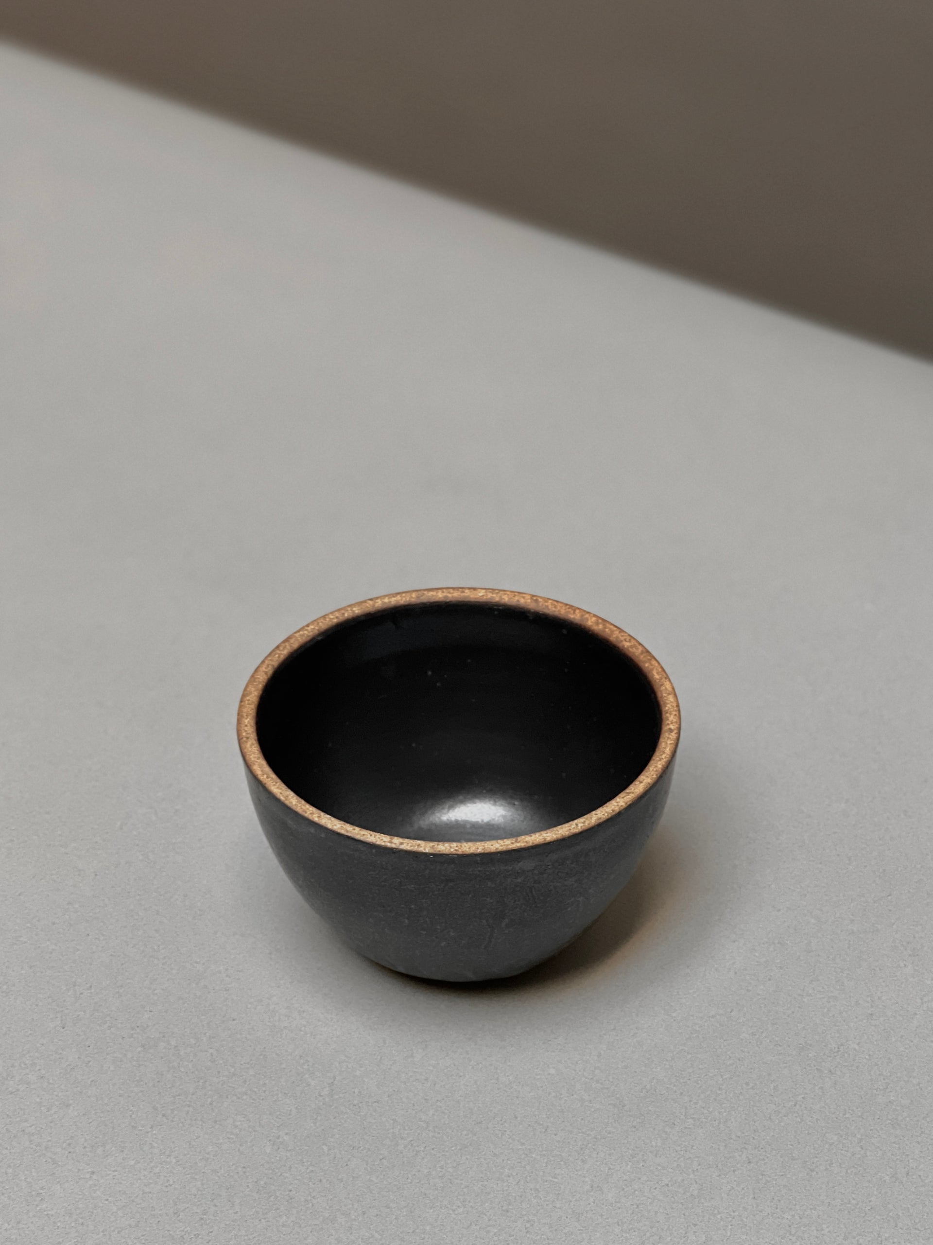 Large Stoneware Smudge Bowl by Incausa, handmade in dark gray with a light-colored rim.