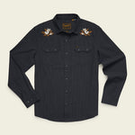 The Howler Brothers Crosscut Deluxe is a black, long-sleeve button-up shirt crafted from soft stretch chambray. It features two chest pockets, classic western yokes for a timeless look, and embroidered white and brown flower designs on the shoulders, all inspired by the rugged style of Howler Brothers.