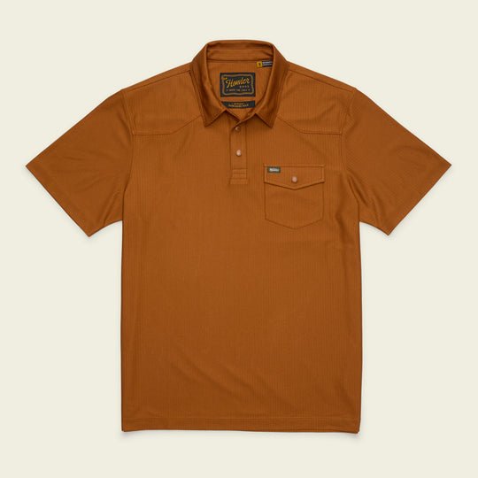 Howler Brothers Ranchero Tech short-sleeve polo in rust, featuring a button-up collar and a single chest pocket, displayed flat against a light background.