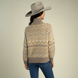 A person wearing a grey cowboy hat and a tan, brown, and cream southwest-inspired Shiloh Sweater by Sendero Provisions Co. with ribbed cuffs.