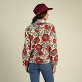 A person seen from behind wears a maroon baseball cap and a Sedona Fleece with a red southwest-print floral pattern.