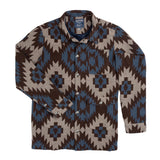 Santa Fe Jacket by Sendero Provisions Co., a Western-style button-down jacket featuring a brown and blue geometric southwest print, a chest pocket, and two lower pockets.