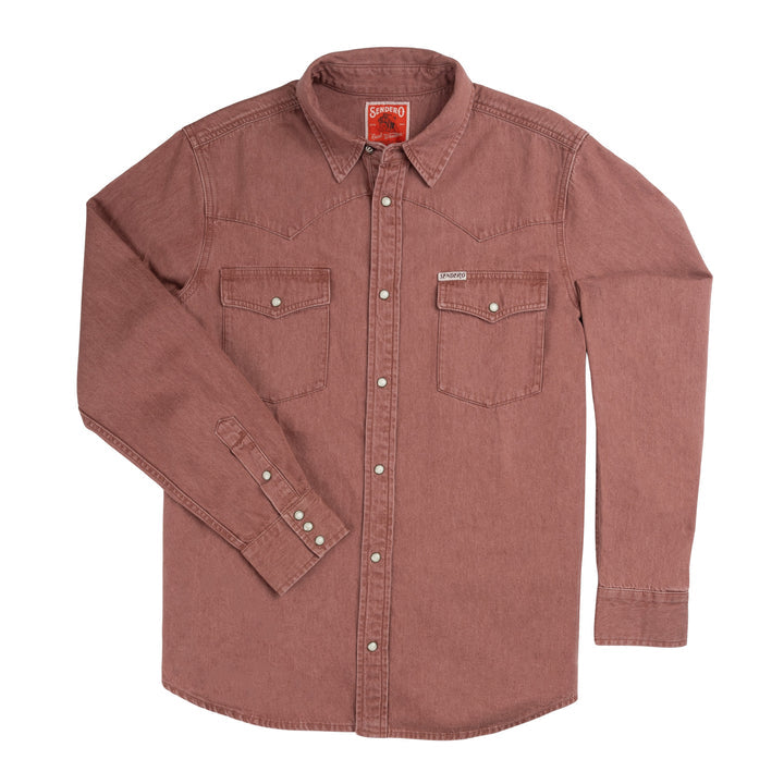 The Wyatt Pearl Snap Long Sleeve Denim Shirt in Madera by Sendero Provisions Co. is a long-sleeve, button-up shirt featuring faded maroon cotton denim, pearl snaps, two chest pockets, and a pointed collar, displayed laid flat on a white background.