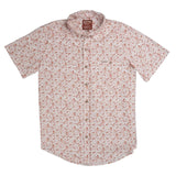 The City Slicker Button Up Short Sleeve by Sendero Provisions Co. is a short-sleeve shirt crafted from a soft hemp blend, featuring a red and beige floral print pattern, a single chest pocket, and a collar. The Sendero Provisions Co. shirt label is visible at the neck.