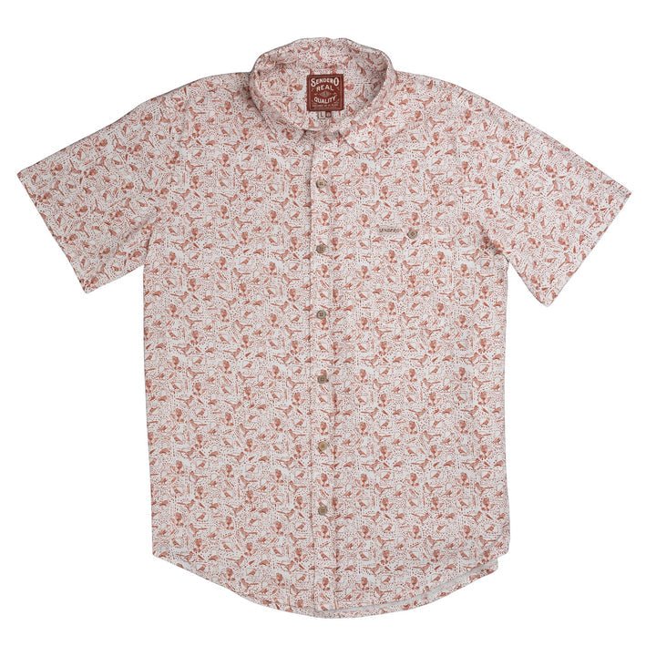 The City Slicker Button Up Short Sleeve by Sendero Provisions Co. is a short-sleeve shirt crafted from a soft hemp blend, featuring a red and beige floral print pattern, a single chest pocket, and a collar. The Sendero Provisions Co. shirt label is visible at the neck.
