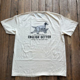 The Bird Dog Series Shirt | English Setter from Ballad Originals is a cream-colored Comfort Colors tee, photographed on a wooden floor. It features an illustration of an English Setter dog and “The Companionable English Setter Ballad of the Bird Dog” printed on the back—perfect for anyone who wants to showcase their love for classic style and their favorite hunting companion.