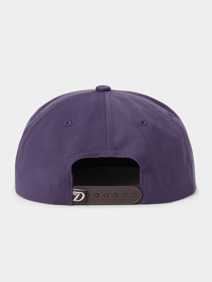 Back view of the Duck Camp Armadillo Hat in purple, featuring an adjustable black snapback closure, displayed against a plain light background.