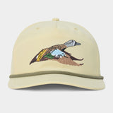 Introducing the Duck Camp Blue Winged Teal Hat by Duck Camp—a beige baseball cap accented with a green cord above the brim and an embroidered duck in flight on the front panel. This adjustable hat is crafted for comfort and style, making it perfect for any outdoor adventure.