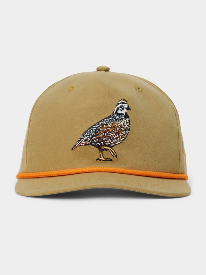 The Duck Camp Bobwhite Quail Hat by Duck Camp features a tan polyester shell, an embroidered quail on the front, and a vibrant orange trim along the brim. This hat offers a comfortable fit with its adjustable snapback closure and is shown against a plain background.