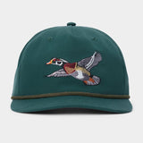 Duck Camp Wood Duck Hat by Duck Camp, a green snapback featuring an embroidered flying duck on the front and a dark green band above the brim. Made with a durable polyester shell and adjustable fit, shown against a plain background.