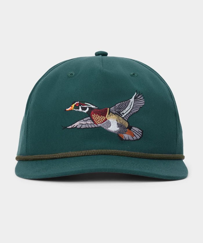 Duck Camp Wood Duck Hat by Duck Camp, a green snapback featuring an embroidered flying duck on the front and a dark green band above the brim. Made with a durable polyester shell and adjustable fit, shown against a plain background.