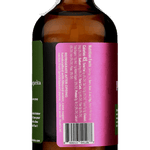 A brown glass bottle with a torn white seal and a magenta label, listing Prickly Pear Syrup ingredients, barcode, and the Yes Cocktail Co. brand name, viewed from the back.