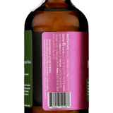 A brown glass bottle with a torn white seal and a magenta label, listing Prickly Pear Syrup ingredients, barcode, and the Yes Cocktail Co. brand name, viewed from the back.