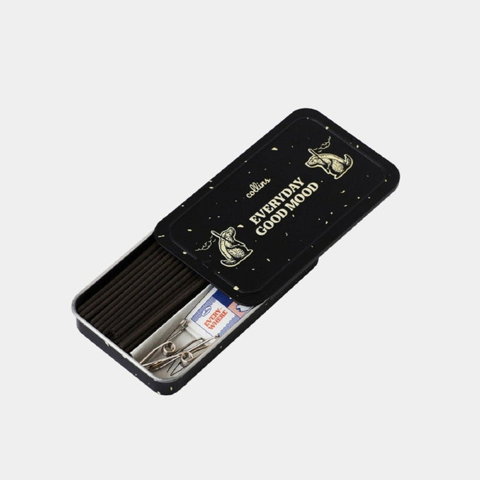 A black metal tin labeled “Room No.11 Incense Sticks | Collins” from the brand Collins contains incense sticks made from natural ingredients, matches, and a metal incense holder, displayed on a light gray background.