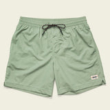 The Salado Shorts by Howler Brothers are light green men’s quick-drying nylon shorts with an elastic waistband, black drawstring, side pockets, and a small white rectangular logo patch on the left hem.