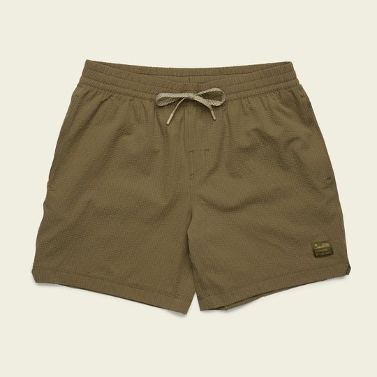The Salado Shorts by Howler Brothers are brown textured men’s seersucker shorts with an elastic waistband, drawstring, and a small rectangular patch on the lower left leg.