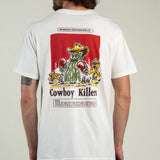A man wearing the Cowboy Killers T-Shirt by Sendero Provisions Co.—a white organic cotton tee featuring a cartoon cactus with boxing gloves and “Cowboy Killers” printed on the back, finished with a soft-touch screen print for lasting comfort.
