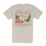 Beige “Hand Tied Flies T-Shirt” by Sendero Provisions Co., made from soft organic cotton and featuring a vintage-inspired fishing graphic with screen-printed text promoting handmade fishing flies, expert advice, and custom gear from Sendero Provisions Co. in Hueco, Texas.