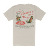 Beige “Hand Tied Flies T-Shirt” by Sendero Provisions Co., made from soft organic cotton and featuring a vintage-inspired fishing graphic with screen-printed text promoting handmade fishing flies, expert advice, and custom gear from Sendero Provisions Co. in Hueco, Texas.