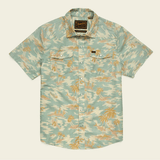 The Howler Brothers H Bar B Snapshirt features a light green and beige tropical palm print, classic pearl snaps, and two chest pockets with button flaps. Inspired by timeless H Bar B style.