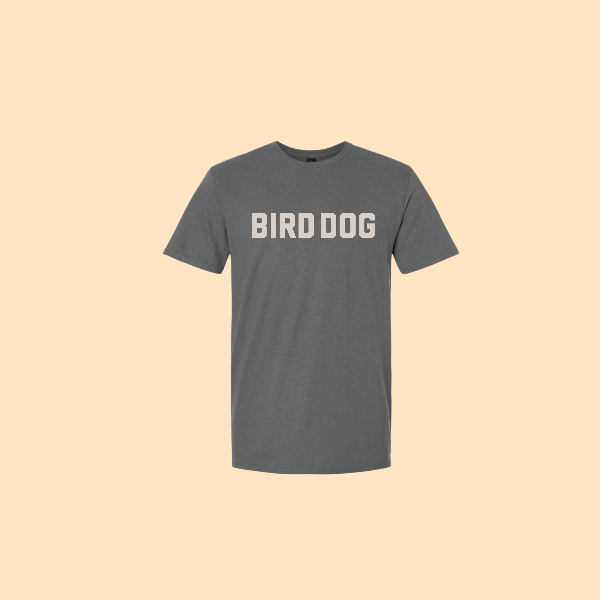Shop Shirt Giveaway | Honor | Ballad of the Bird Dog by Ballad Giveaway—a gray short-sleeve cotton tee featuring “BIRD DOG” in bold white capital letters across the chest, shown on a plain beige background.
