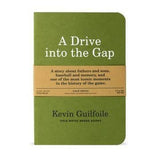 A green "A Drive Into The Gap | Field Notes" notebook by Field Notes, featuring a brown band describing it as a story of baseball, fathers and sons, and memory.