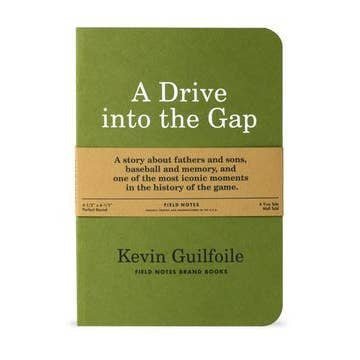 A green "A Drive Into The Gap | Field Notes" notebook by Field Notes, featuring a brown band describing it as a story of baseball, fathers and sons, and memory.