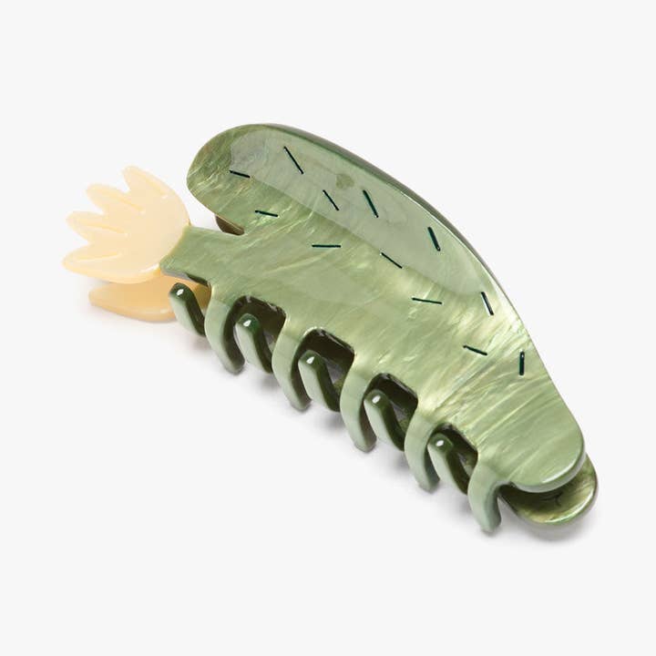 The Desert Bloom Succulent Claw Clip by Winona Irene is a playful hair accessory, crafted from cellulose acetate with leafy beige and dark details, adding charming style to your look.