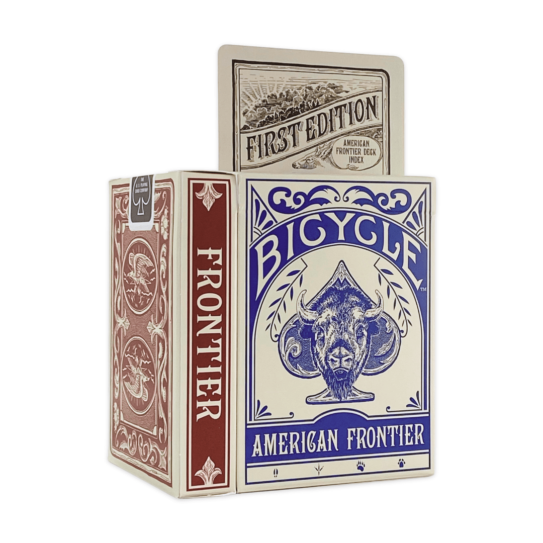 A partly open American Frontier Two Deck Card Set by Mollyjogger displays a "First Edition" card. The box, in blue, red, and cream with ram artwork, features hand-drawn cards inspired by wildlife illustrations.