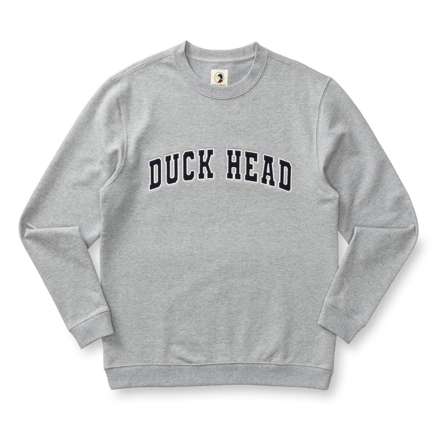 The Duck Head Applique Crewneck Sweatshirt is a light gray cotton crewneck with vintage-style ribbing and bold "DUCK HEAD" lettering across the chest.